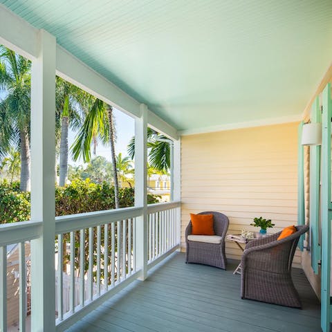 Gaze out at leafy palm trees from your private balcony