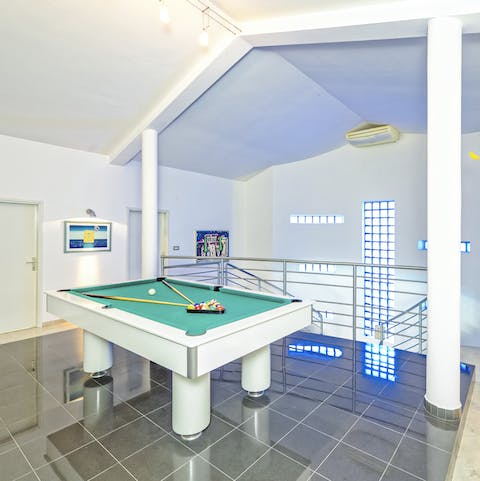 Challenge friends to a game of pool after dinner in the sleek and modern interior