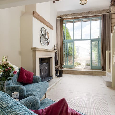 Cosy up under the high ceilings in front of the grandiose stone fireplace