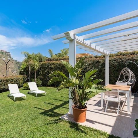 Select a spot to relax in, the sun loungers or the swing seat