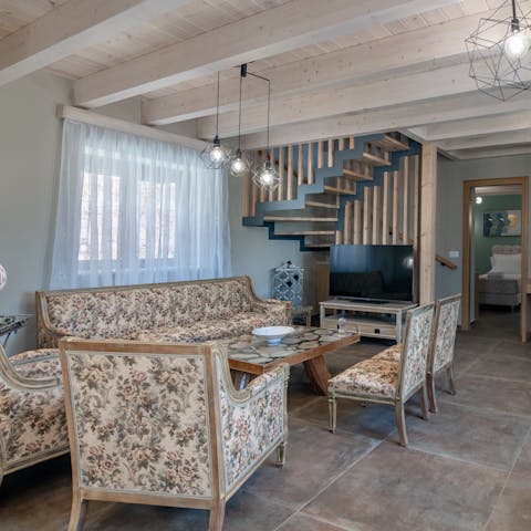 Snuggle up for a cosy evening of movies and wine in the comfy living room