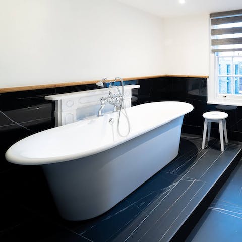 Relax in your deep, standalone tub after a long day of exploring, glass of wine in hand