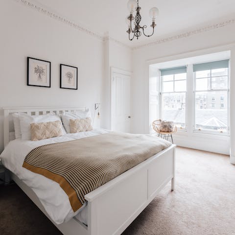 Wake up to views over Edinburgh's rooftops in the elegant master bedroom