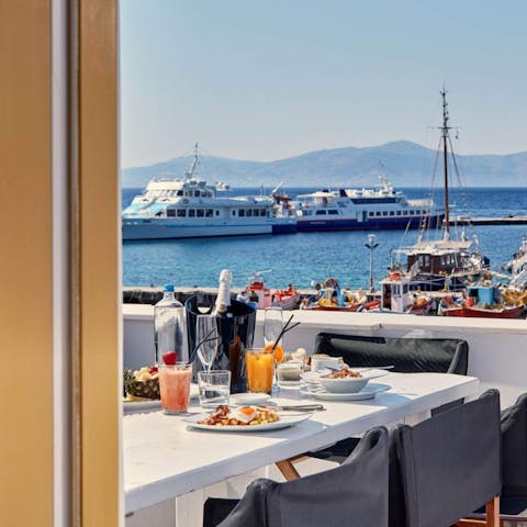 While away your afternoons sipping wine on the terrace, overlooking the old harbour and the Aegean Sea