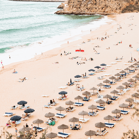 Sink your feet into the golden sands of Olhos de Água beach