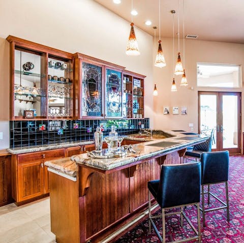 Mix some drinks at the home's impressive bar