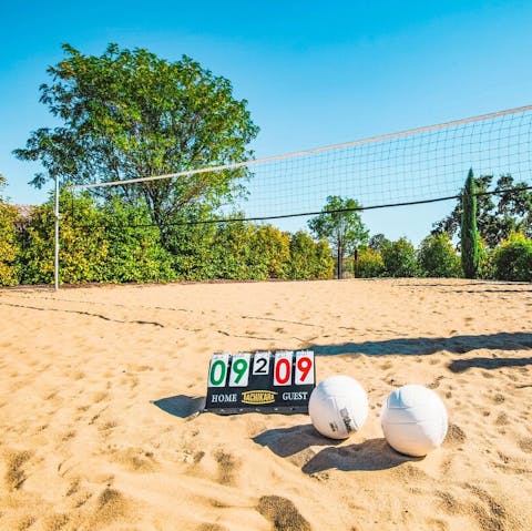 Play a game of beach volleyball