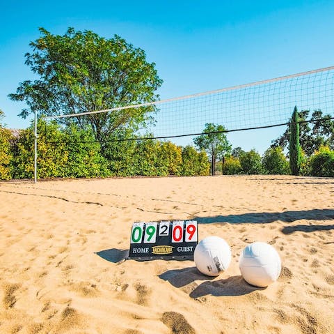 Play a game of beach volleyball