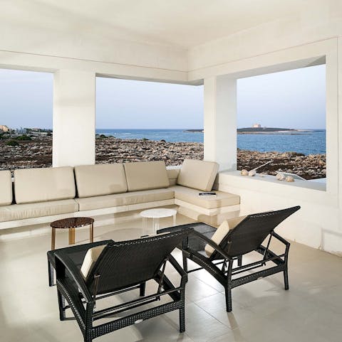 Unwind in the charming living room, framed by Ionian sea views