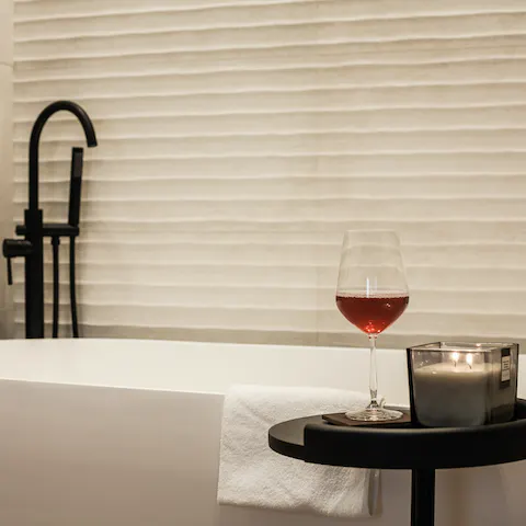Treat yourself to a soak in the freestanding bathtub with a glass of wine in hand