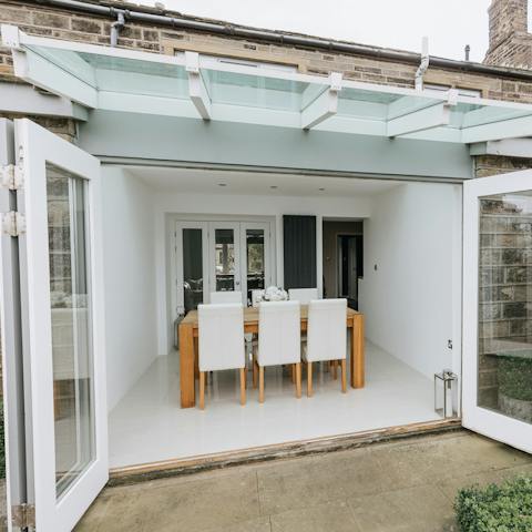 Fold back the glass doors to create an al fresco dining room