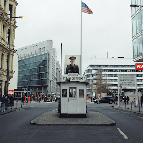 Visit Checkpoint Charlie, a thirty-minute walk from your door