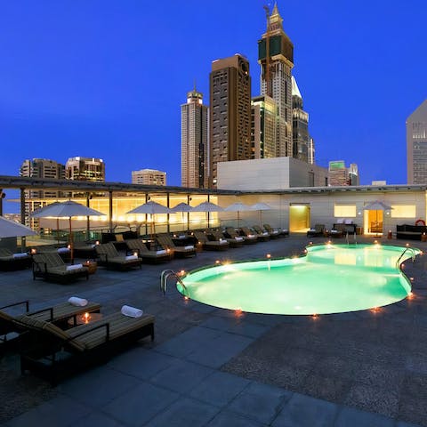 Watch the city skyline sparkle at night while enjoying a cocktail
