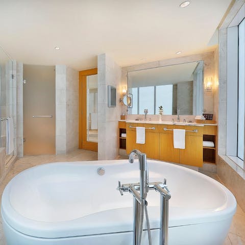 Soak in the huge luxurious tub while looking out at the city