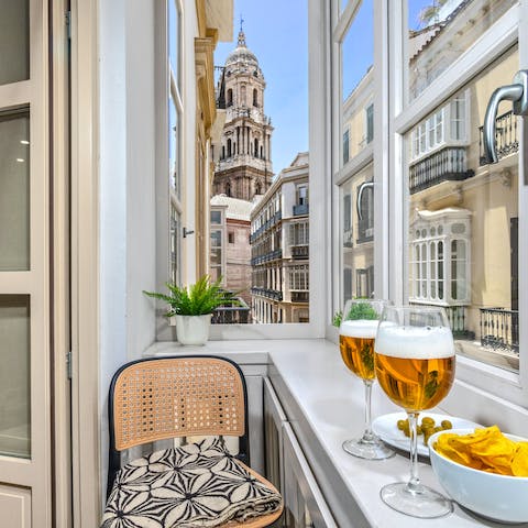 Look out to views of Malaga Cathedral from the apartment's glazed balcony