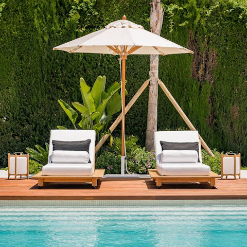Sit back and relax by the pool with a drink in hand