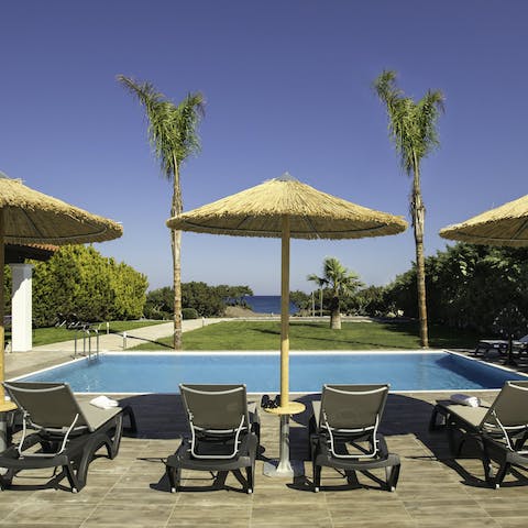 Stretch out poolside under the shade of your parasol