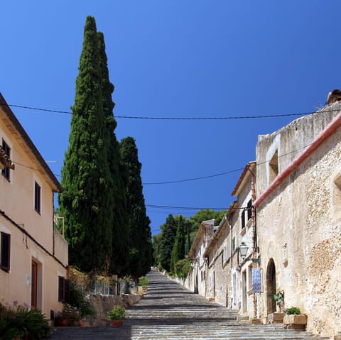 Stay just a short walk away from the old town of Pollenca and climb its steps, ducking into shops along the way