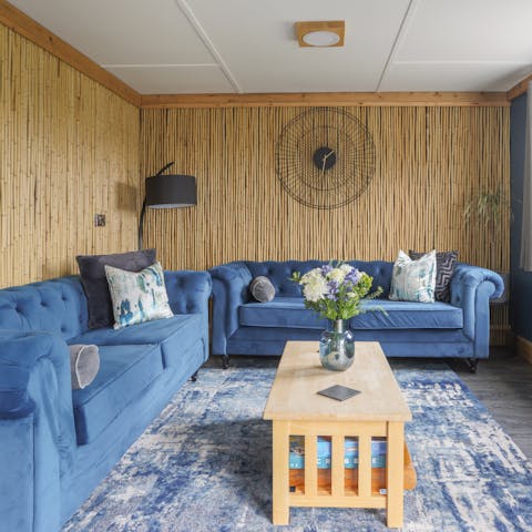 Cosy up on the blue velvet sofas for a board game or movie night
