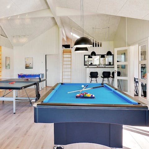 Keep entertained with a pool table, table tennis and tennis football all in one room