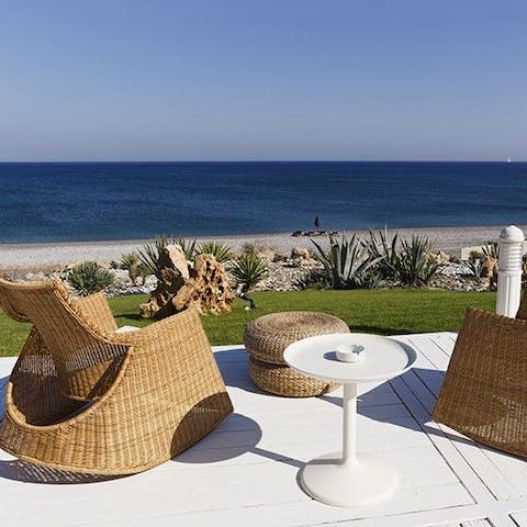 Soak up the sun on the super-comfy chairs looking out across the Aegean Sea