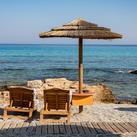 Sit by the gentle rays of the sea at Lachanias Beach, just an eleven-minute-walk away