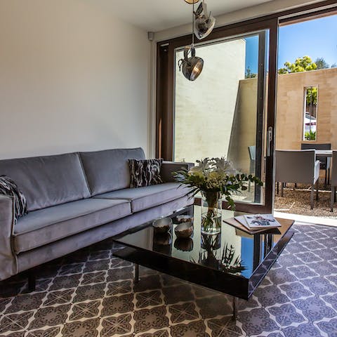 Kick back in the elegant living area as the breeze flows through the open patio doors