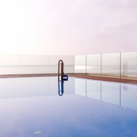 Enjoy a refreshing dip in the rooftop infinity pool