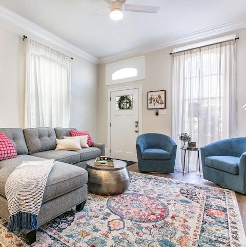 Relax in the sunny living room, with big windows letting the sunlight stream in