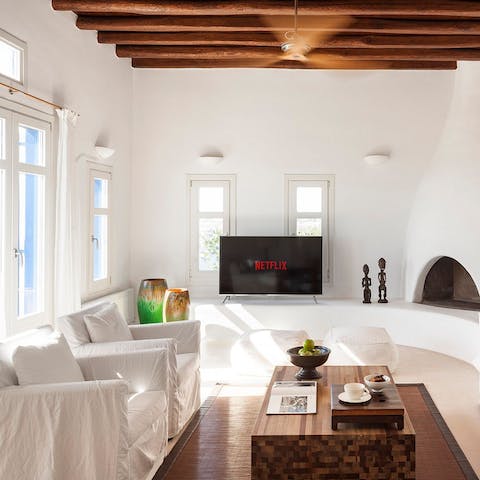Get cosy in the white-washed living room and watch a Netflix film