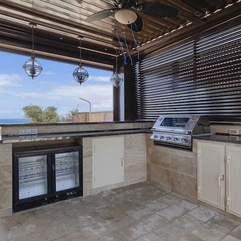 Get your cook on in the outdoor kitchen complete with grill and wine cooler