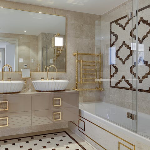 Indulge in a spa-worthy soak in the tub in the main bedroom's marble bathroom at the day's end