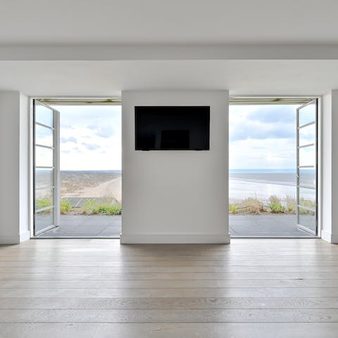 Open the doors to the terrace with incredible views across the bay