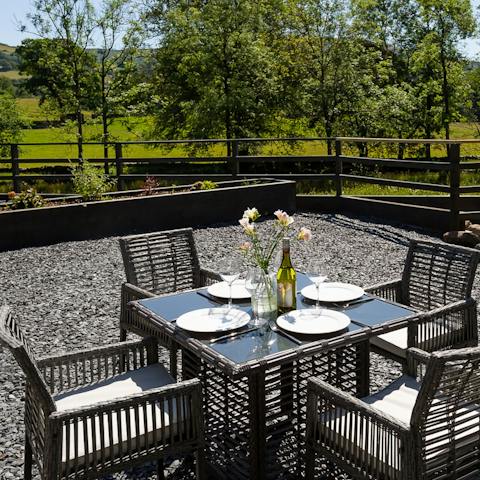 Set the table on the patio and dine outside amidst the trees