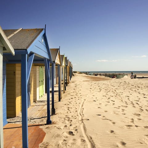 Make the five-minute walk to the beach-hut-lined shore for a stroll