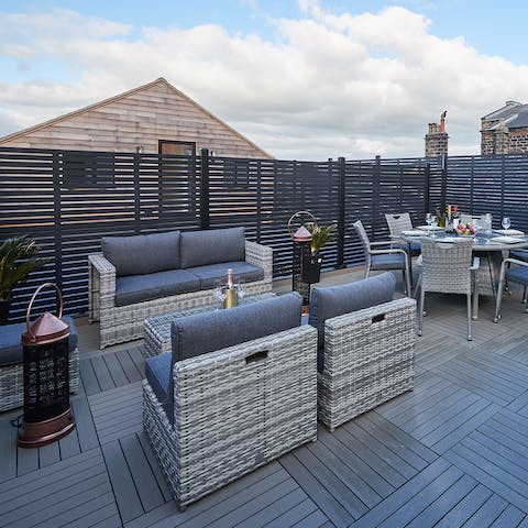 Get comfy and admire views over town from the outdoor sofa