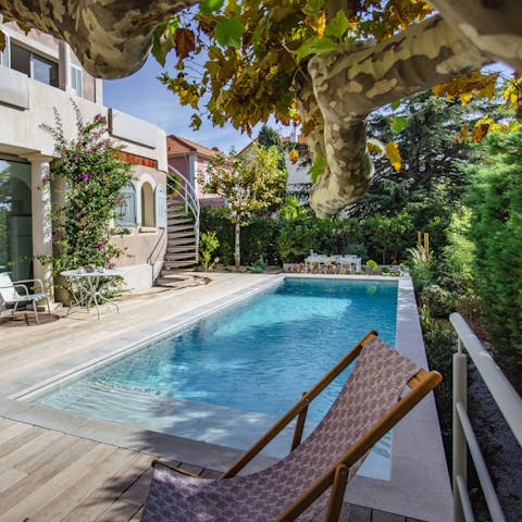 Spend a lazy afternoon relaxing with a book by the pool