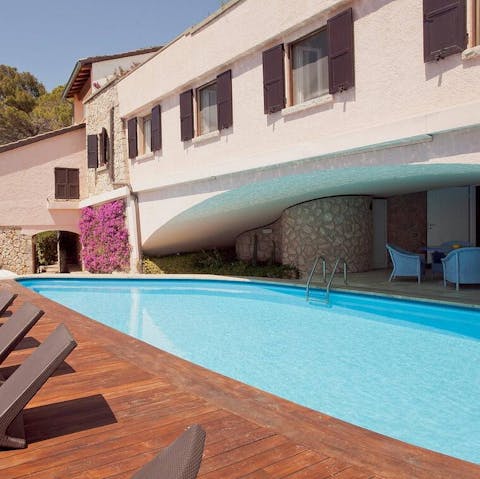 Step out of the private pool and sunbathe or enjoy a drink in the shade