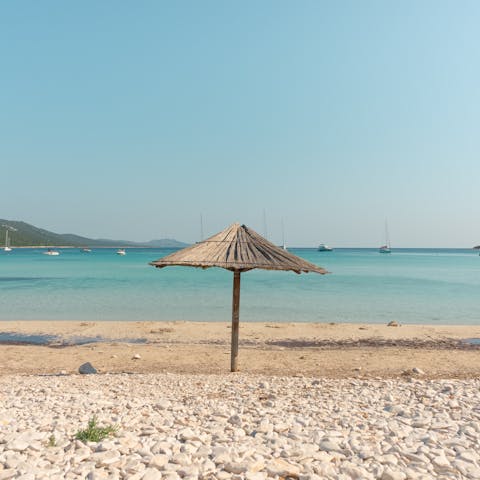 Swim in the shallows of Cala Rossa Beach – it's a short walk away