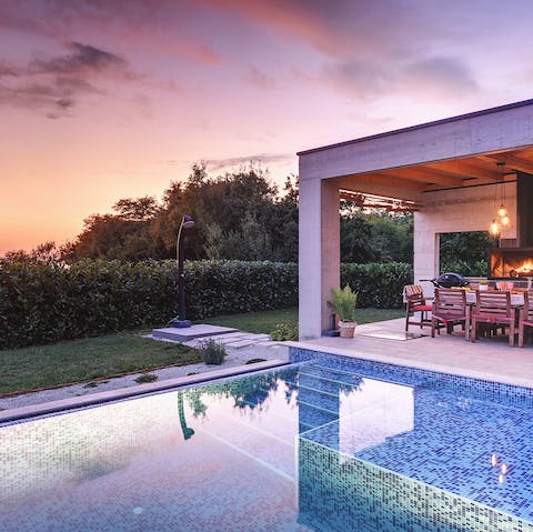 Take a sunset dip in the pool with your favourite cocktail in hand 