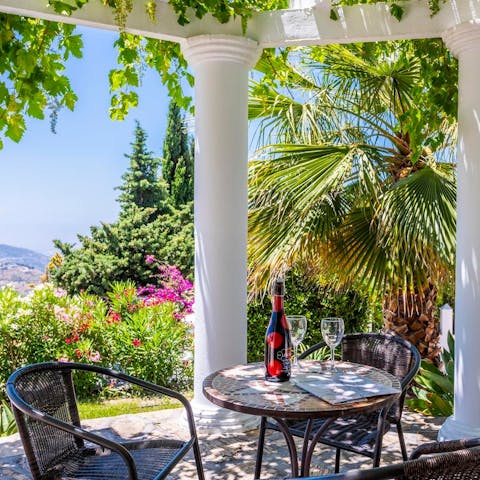 Enjoy cocktail hour underneath the leady pergola and admire the views