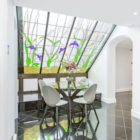 Sit down for an elegant dinner beneath the stunning stained glass window