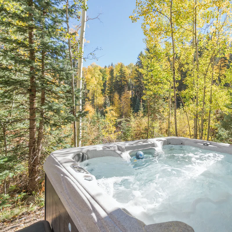 Enjoy a beer in the hot tub overlooking the forest