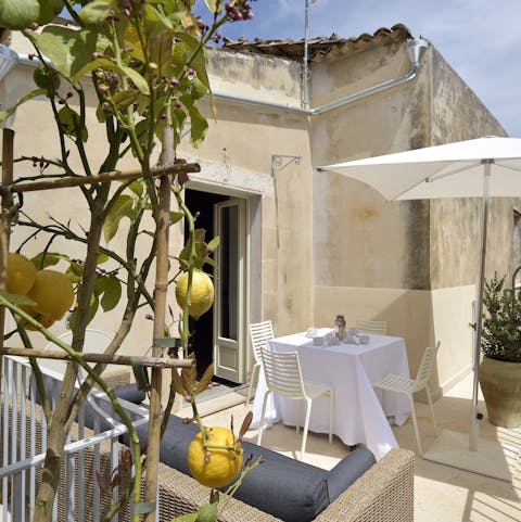 Relax with a glass of wine on the terrace with its lemon tree