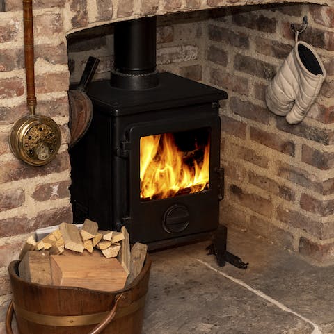 Cosy up by the traditional wood burner fireplace