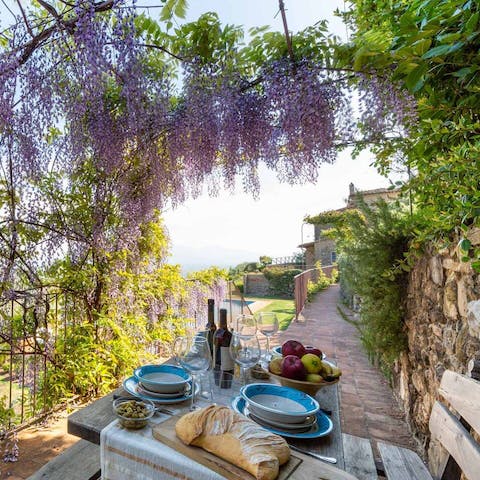 Break open a bottle of vino rosso in the outdoor dining area, draped in flowers