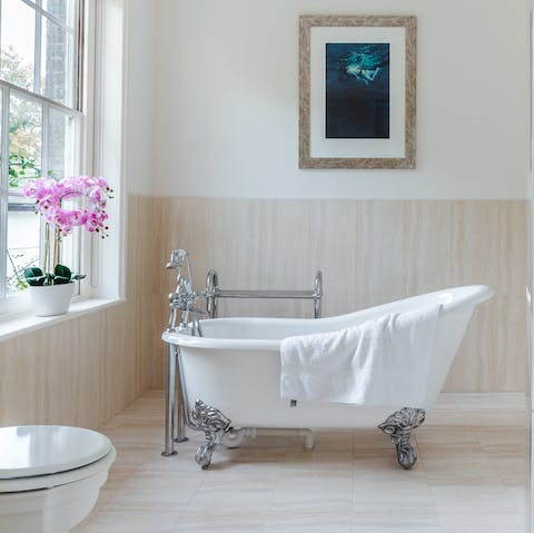 Treat yourself to a soothing bubble bath in the elegant freestanding tub