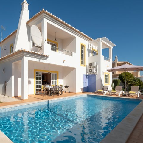 Float under the clear blue skies of Lagos in the private pool