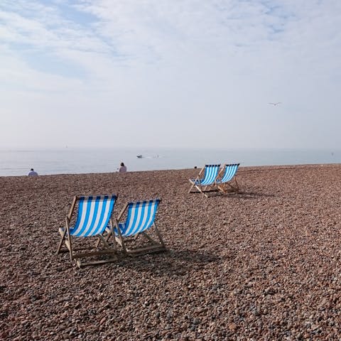 Sit back and relax in a deckchair on Brighton Beach, a five-minute walk away