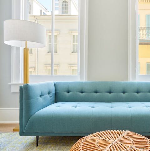 Mix your favourite cocktail and get comfortable on the powder blue sofa for a relaxed night in